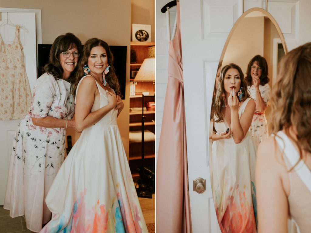 Mom puts on bride's wedding dress and bride puts on lipstick in mirror at-home Atlanta GA backyard wedding FL elopement photography