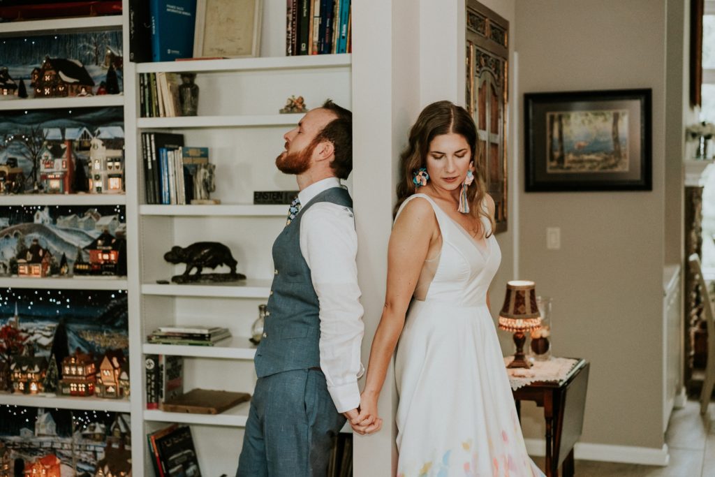 Bride and groom hold hands first touch at home wedding Atlanta GA FL elopement photographer