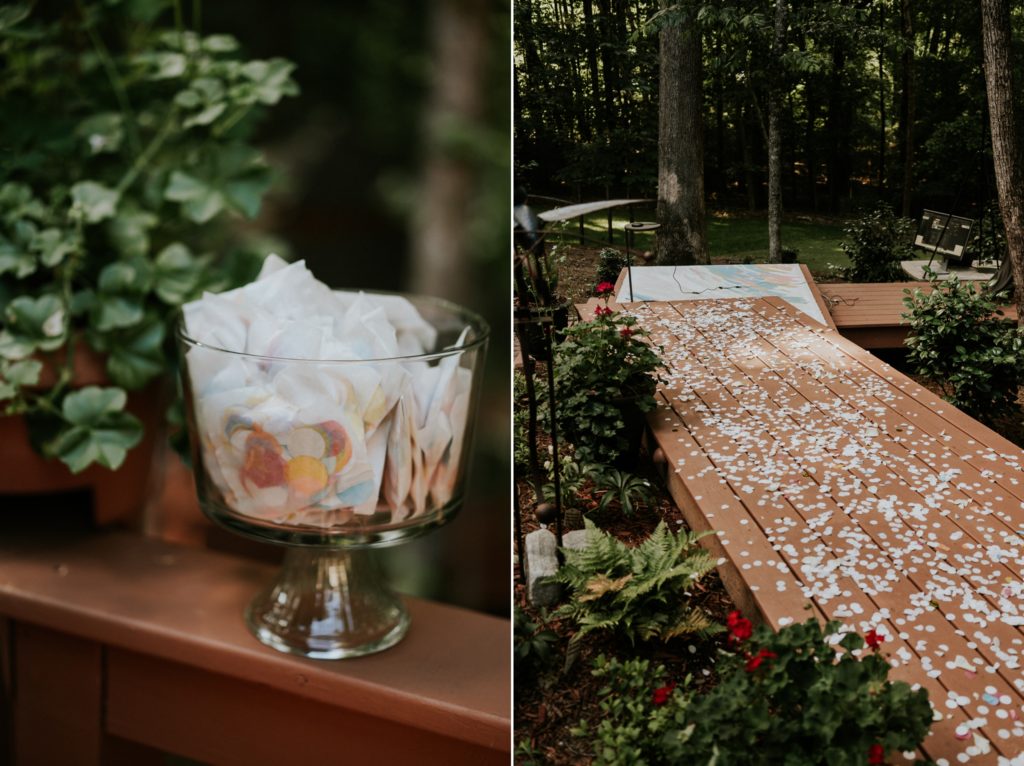 Eco-friendly confetti display scattered on wood deck wedding aisle in woodsy backyard Atlanta GA elopement