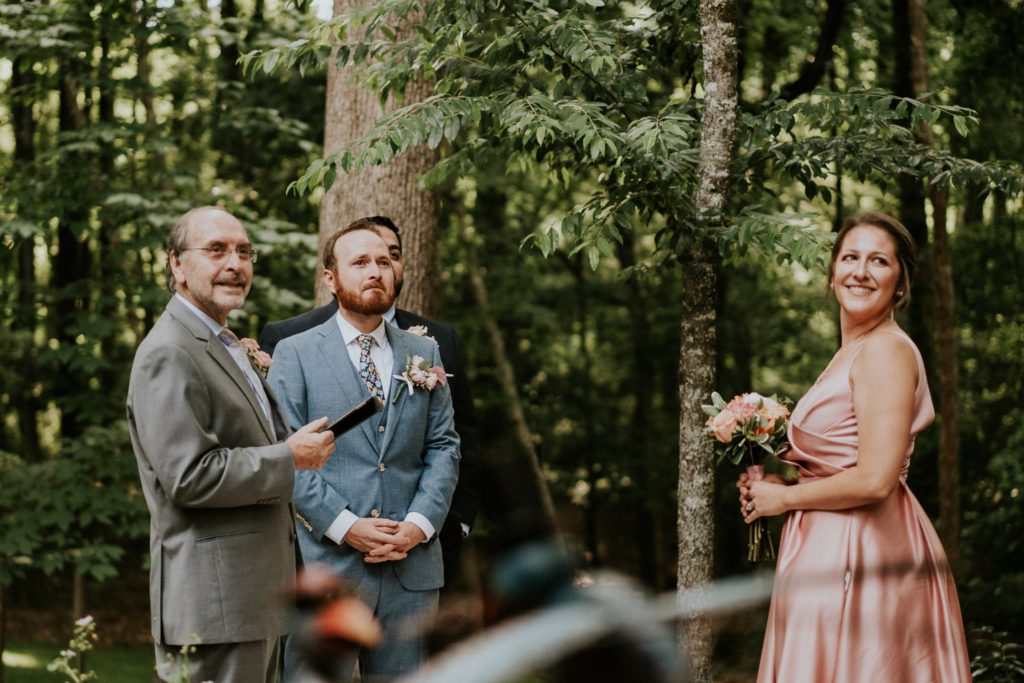 Groom sees his bride walk down aisle woodsy backyard wedding Duluth GA