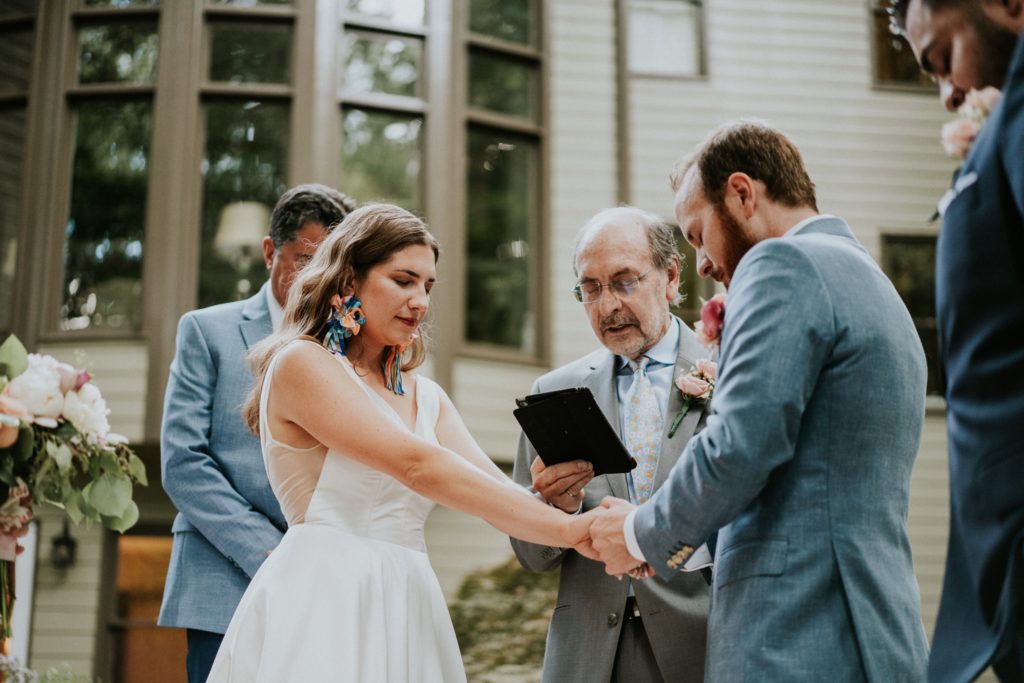 Bride and groom hold hands in Duluth GA wedding ceremony