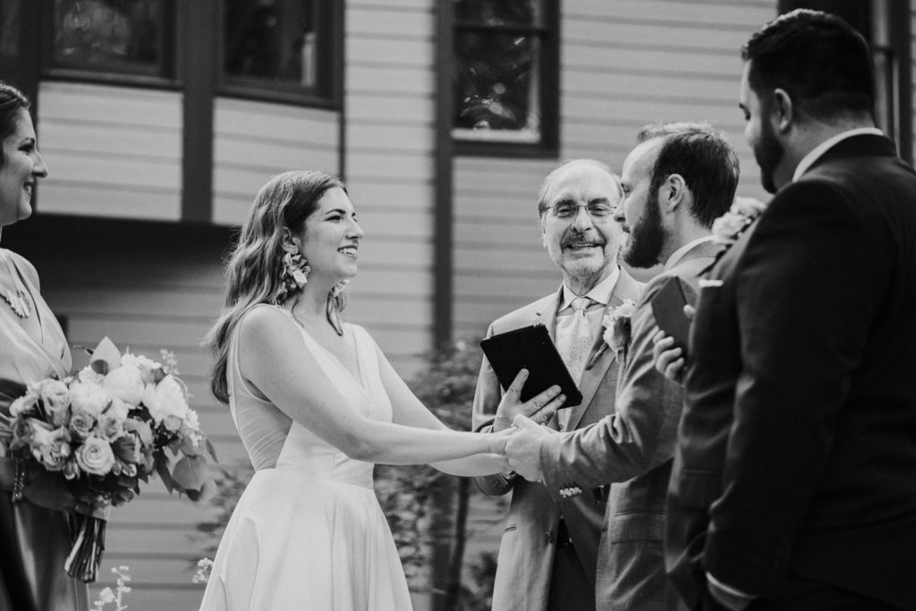 Bride and groom hold hands in Duluth GA wedding ceremony
