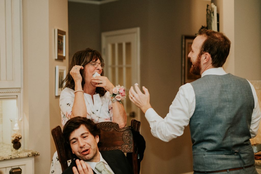 Groom feeds mother in law cake