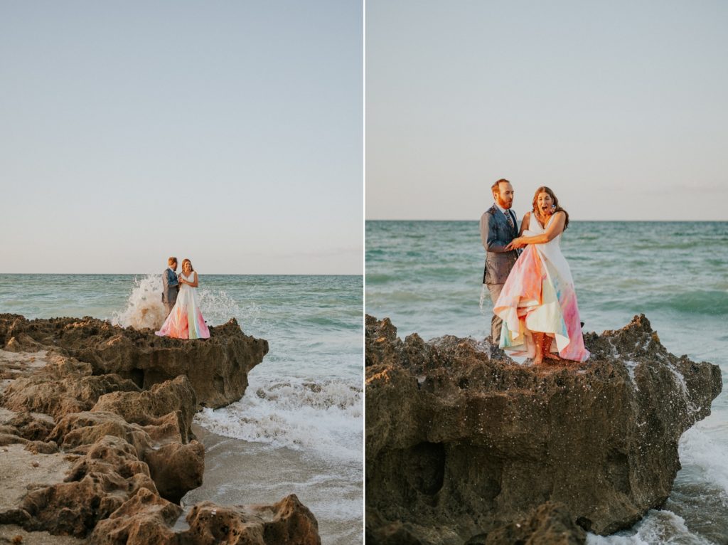 Bride and groom get soaked by waves on rocky beach House of Refuge Stuart FL elopement