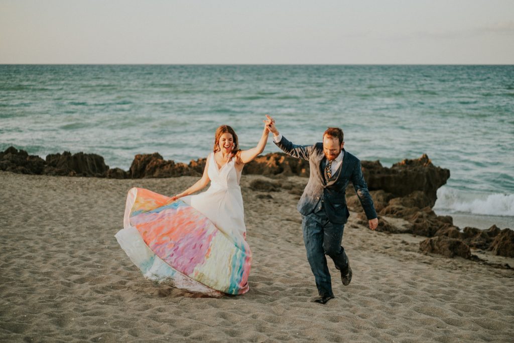 Bride and groom dance holding hands rocky beach Stuart FL elopement photography