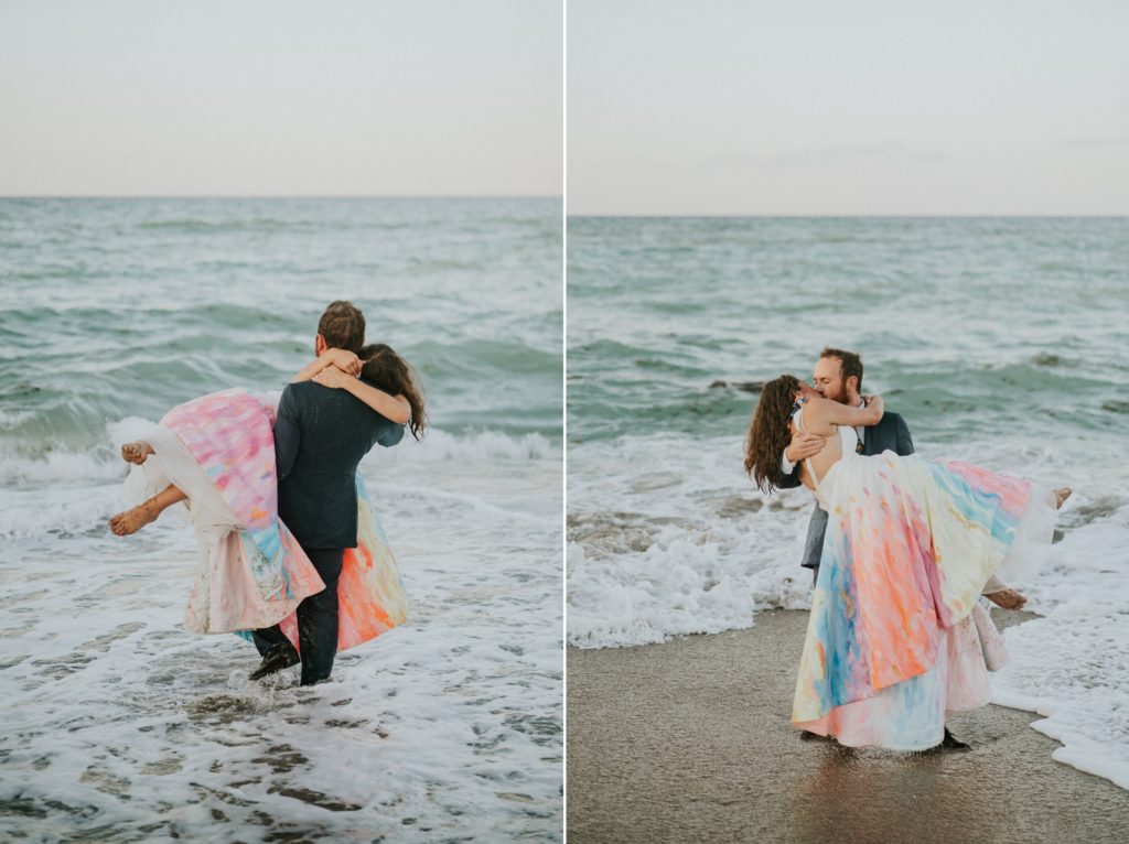 Groom picks up bride in ocean waves House of Refuge beach wedding Stuart FL elopement photography