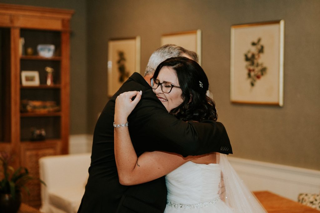 Dad and bride hug during first look