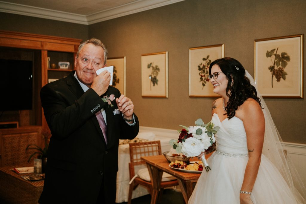 Dad dries tears during first look with daughter on wedding day