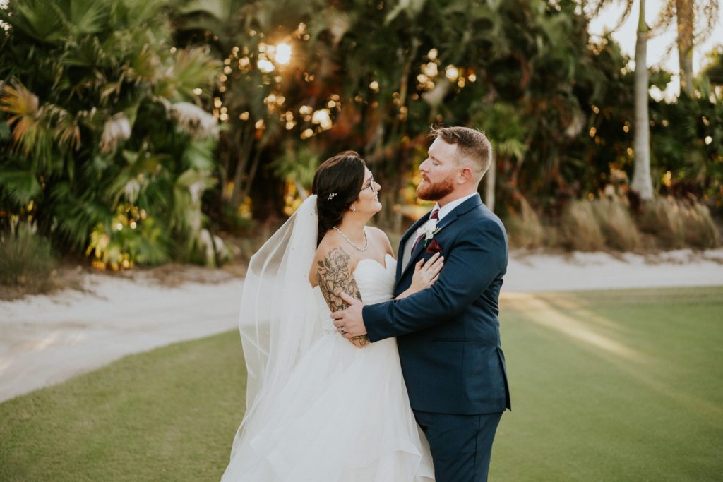 Bride and groom hold each other palm tree sunset Wanderers Club wedding FL photography