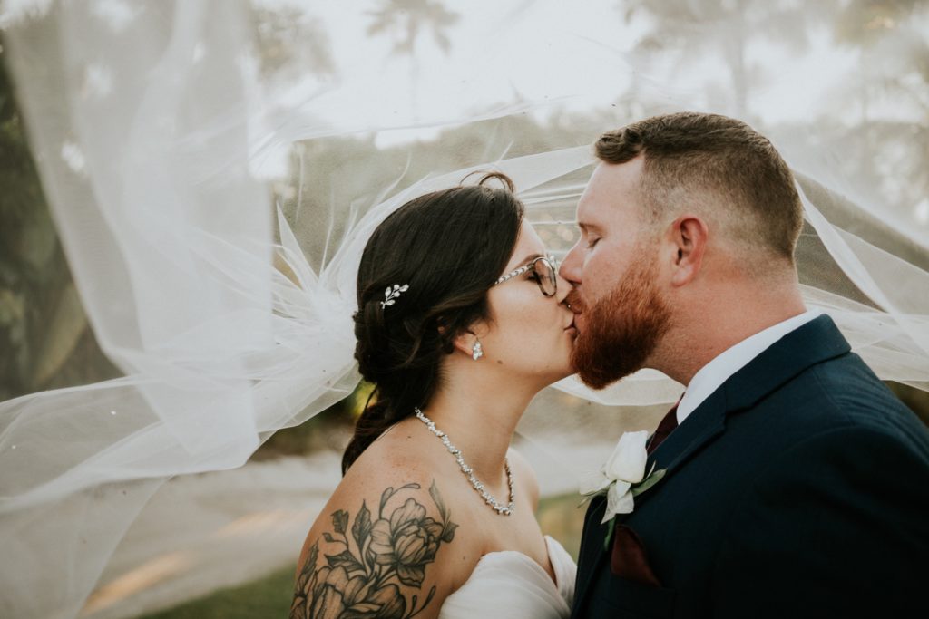 Wedding couple kiss under veil Wanderers Club Wellington FL photographer