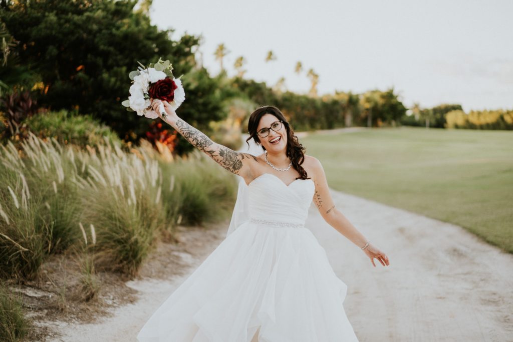 Bride throws bouquet in air bridal portraits FL photography