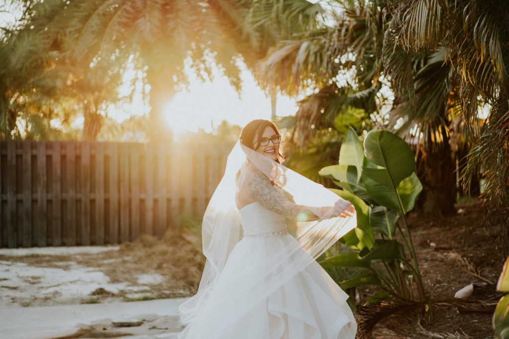 Bride twirls veil sunset golden hour FL wedding photography