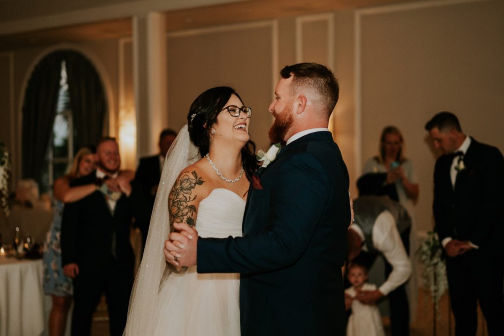 Bride smiles at groom first dance Wanderers Club Wellington FL wedding photography