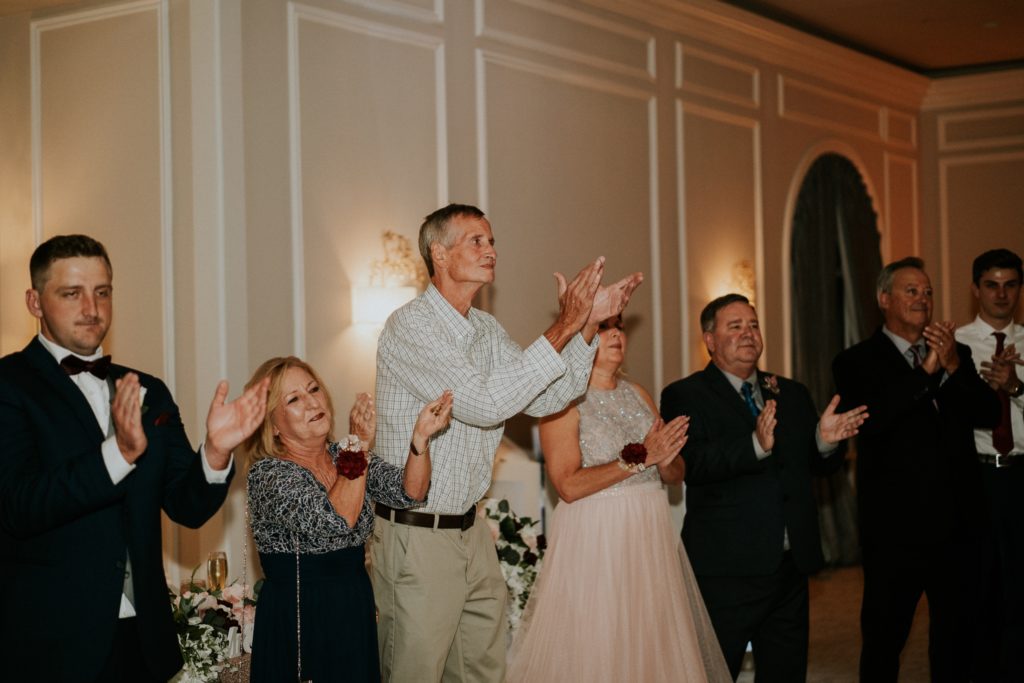 Wedding guests clap during first dance