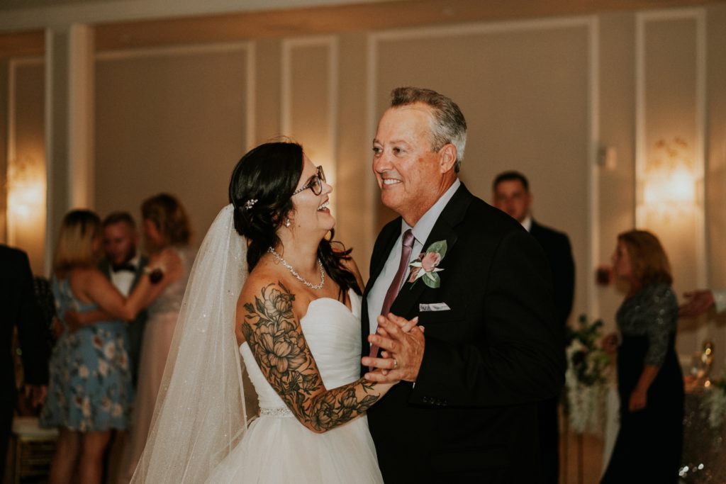 Bride smiles at dad during father daughter dance Wanderers Club Wellington FL wedding photography