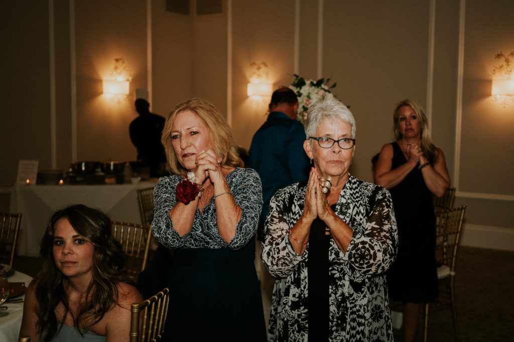 Family clapping at wedding reception