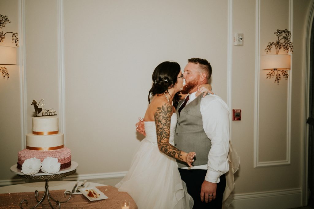 Wedding couple kiss after cake cutting