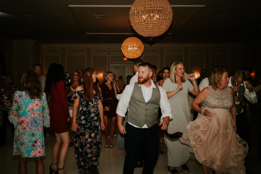 Groom dancing with guests at Wanderers Club wedding reception Wellington FL photographer