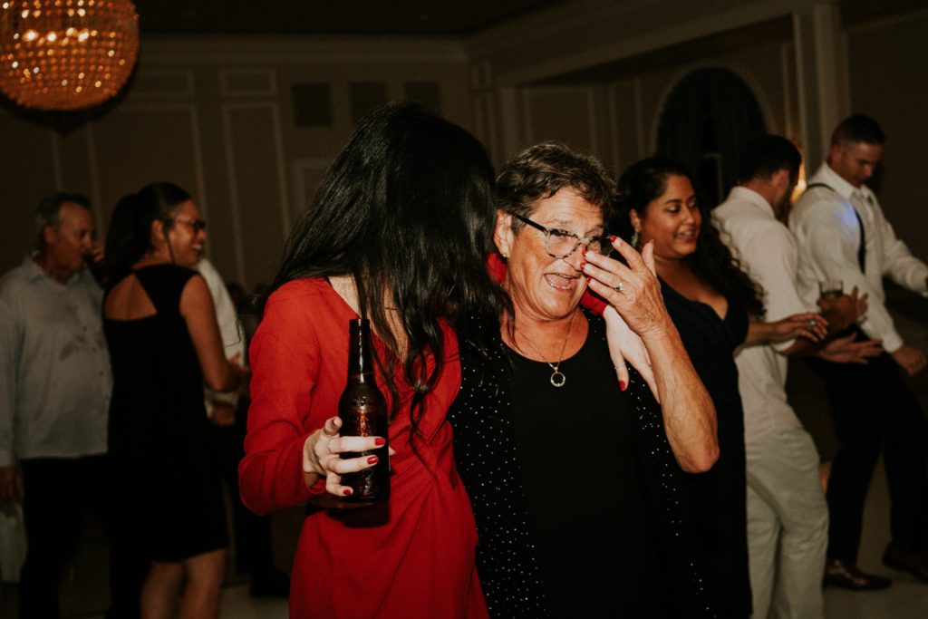 Young woman and elderly woman laugh with beer at Wanderers Club wedding reception Wellington FL photographer