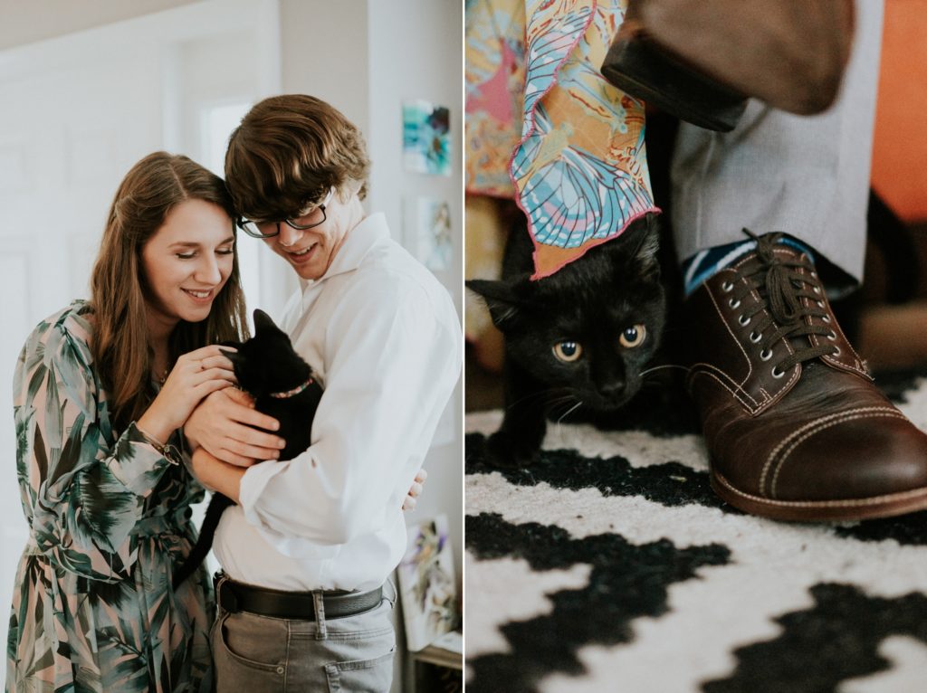 Bri and Aaron pet their black kitten and it peeks out from behind shoe