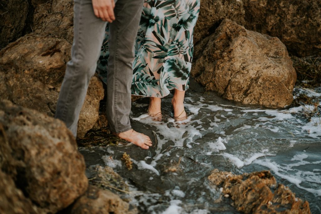 DuBois Park Jupiter elopement couple dip feet into pool of water in jetty rocks