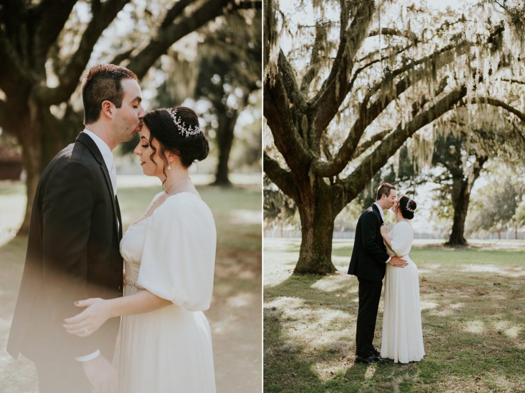 Groom kisses bride under spanish moss tree at Casa Lantana Brandon FL wedding