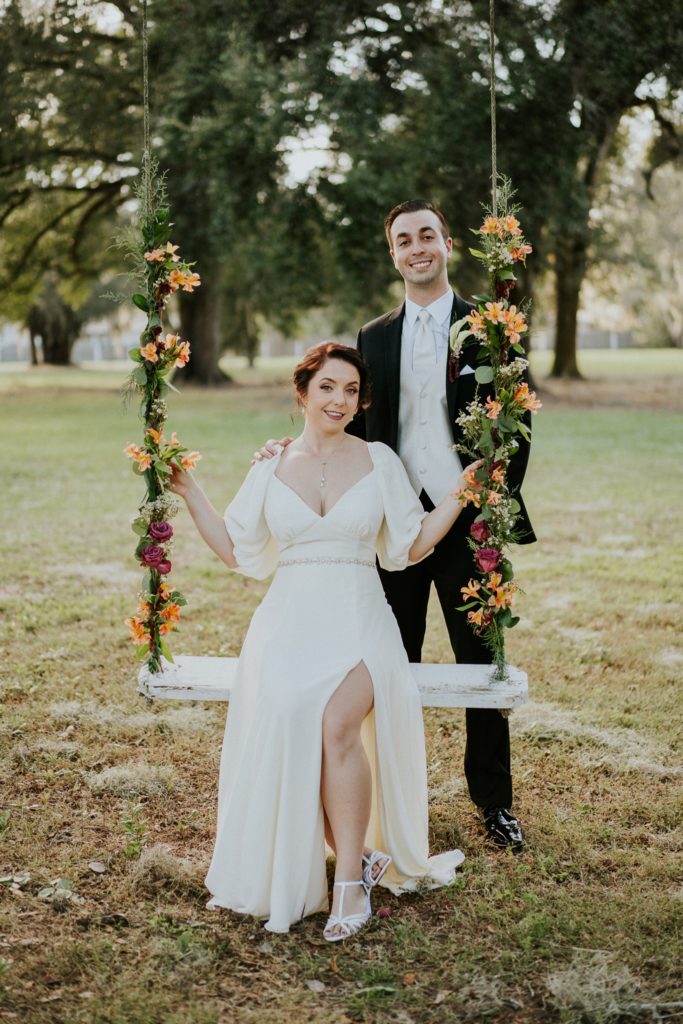 Casa Lantana wedding flower swing with bride and groom portrait