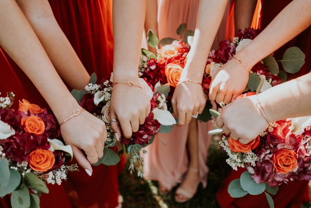Group of wrists show off gold knot bracelet bridesmaid gifts Casa Lantana Brandon FL wedding