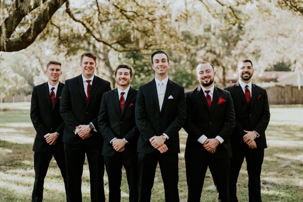 Groomsmen in black and burgundy red at Casa Lantana Brandon FL wedding