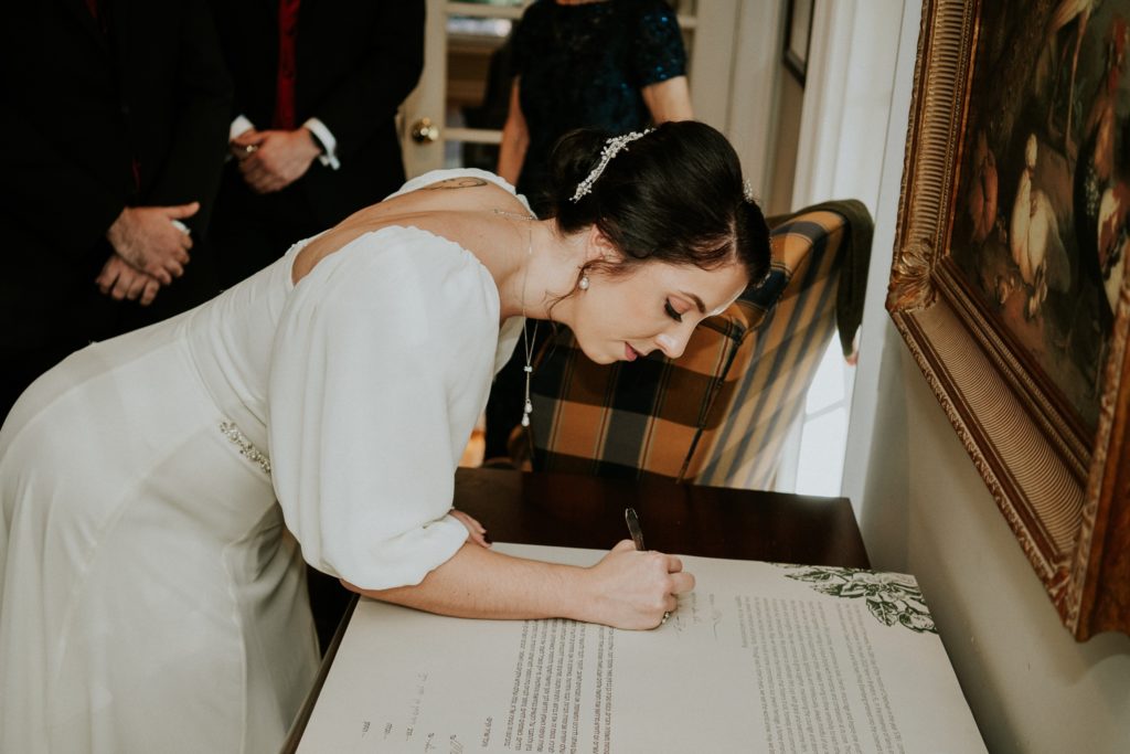 Bride signing ketubah