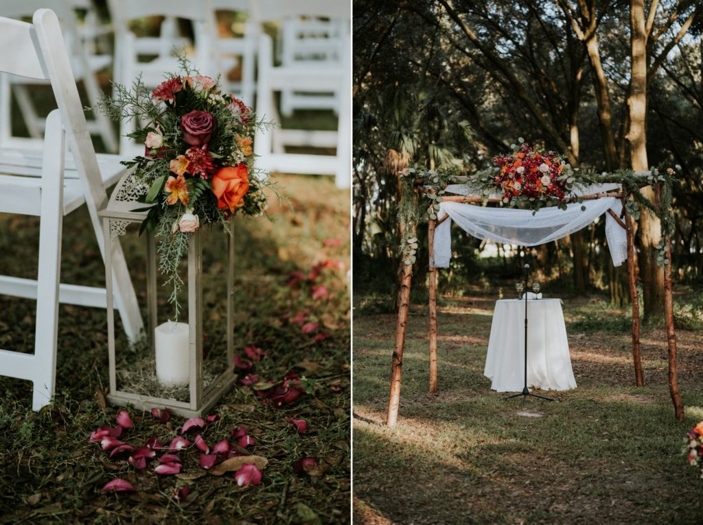 Ceremony details with lantern and red, orange, pink rose flowers on handmade chuppah Casa Lantana Brandon FL wedding