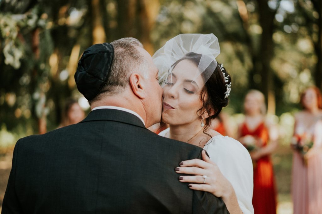 Dad kisses bride wearing vintage birdcage veil at Casa Lantana Brandon FL wedding