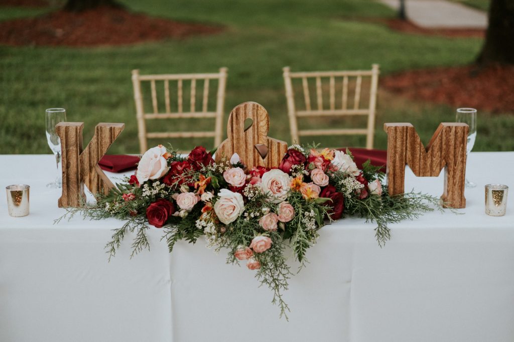 Wedding sweetheart table with K & M wooden block letters and roses