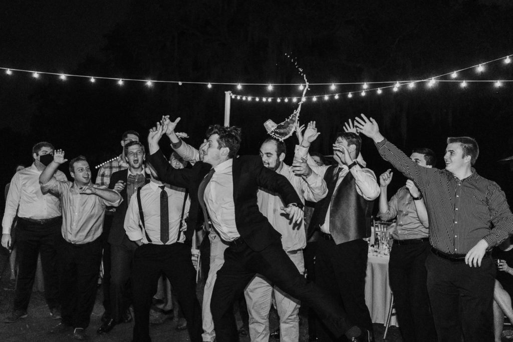 Wedding guest catches garter toss and spills drink in midair