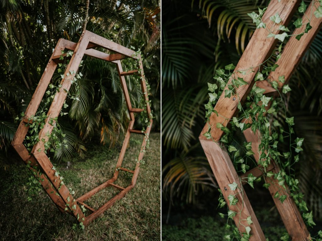 Geometric hexagon wedding arch covered in green vines