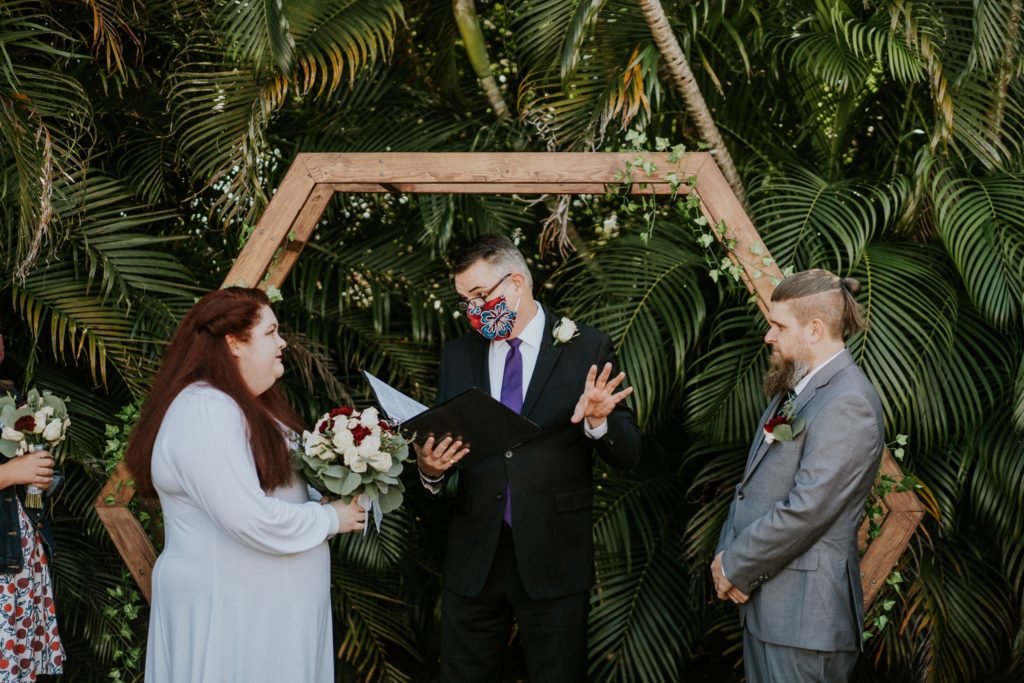 Officiant reads during backyard wedding ceremony