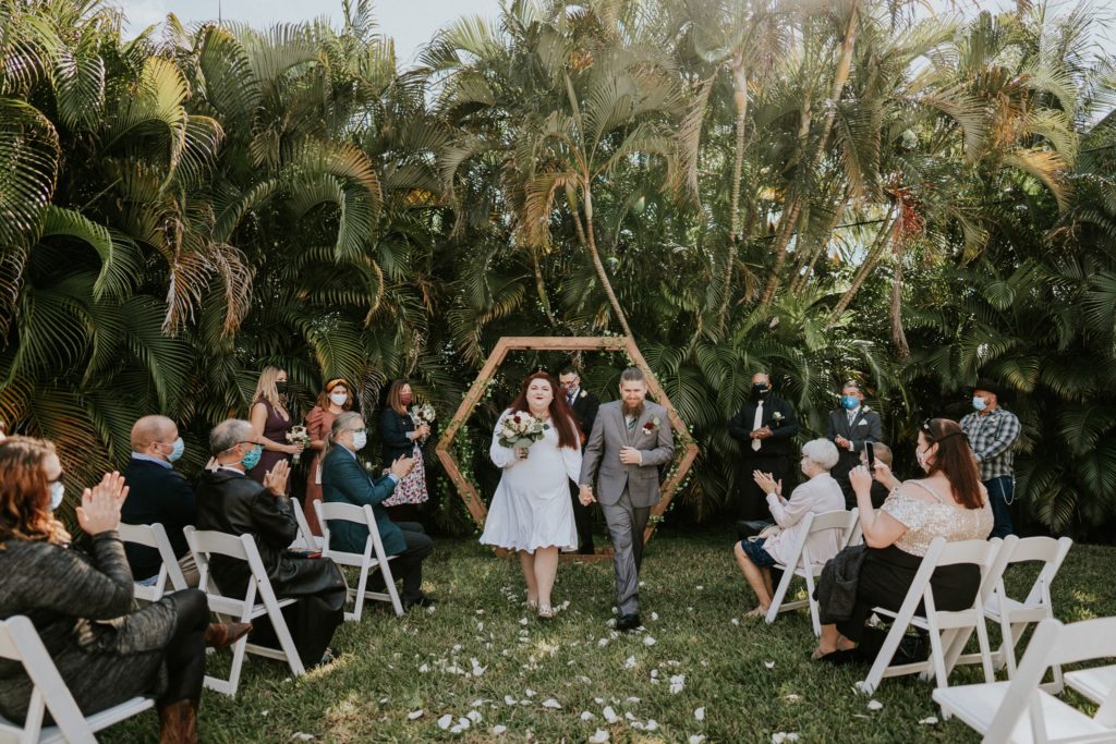 West Palm Beach Florida backyard wedding ceremony with palm trees and geometric hexagon arch