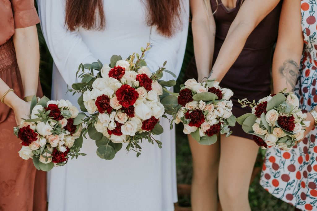 Bridal and bridesmaid bouquets with red and white roses from The Bouqs Co.