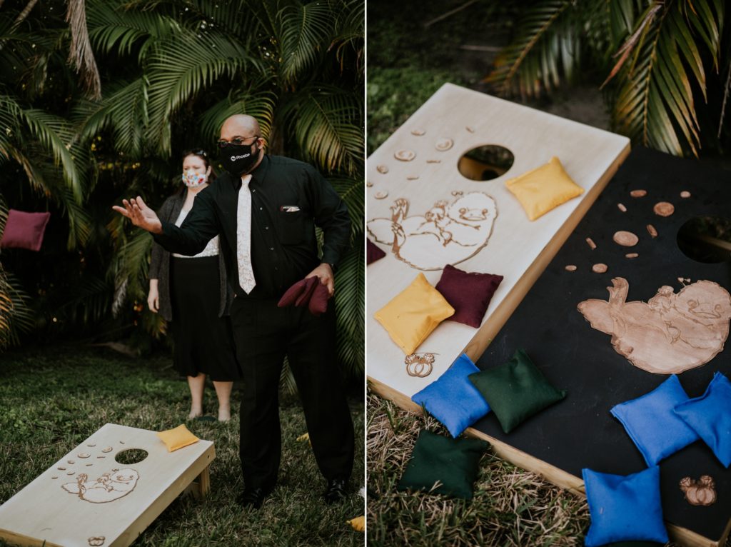 Wedding guest playing corn hole with Harry Potter theme boards with nifflers