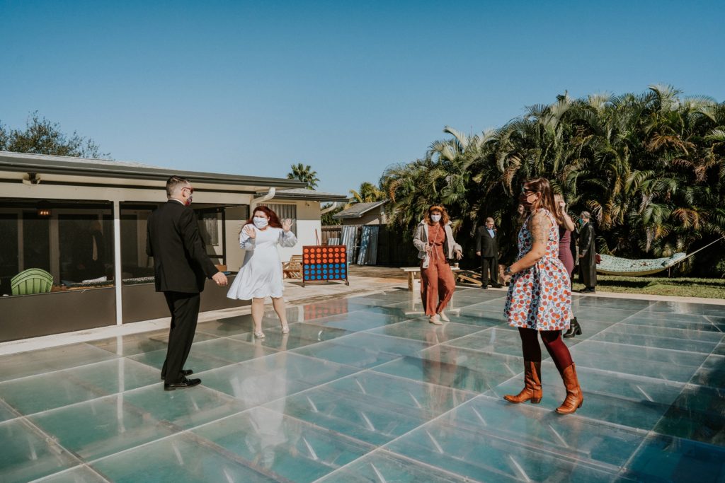 Florida backyard wedding reception dancing on pool dance floor