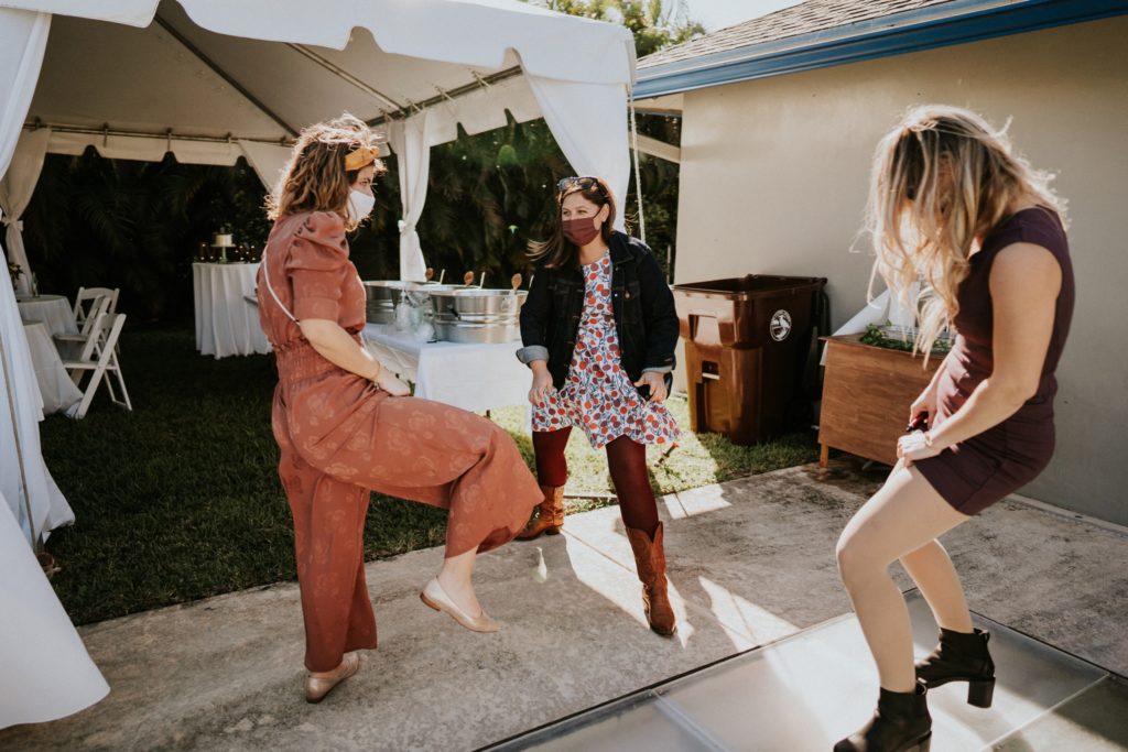 Bridesmaids dancing in backyard wedding