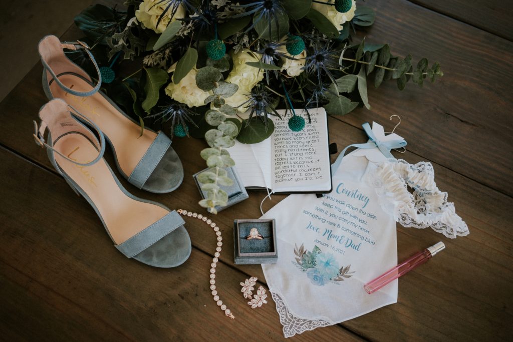 Dusty blue and greenery wedding details with custom keepsake handkerchief