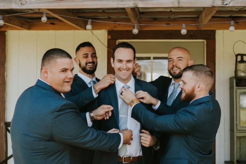 Groomsmen help groom with Jos. A. Bank attire at Cattleya Chapel Vero Beach FL wedding