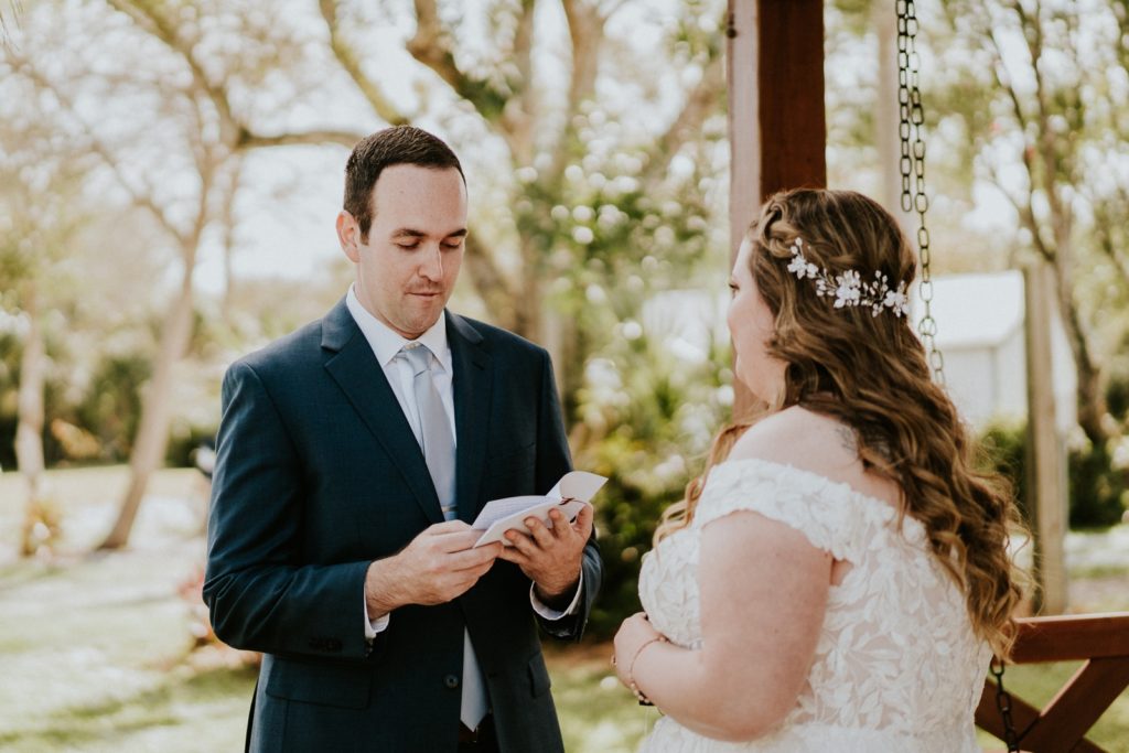 Groom reads private vows from vow book