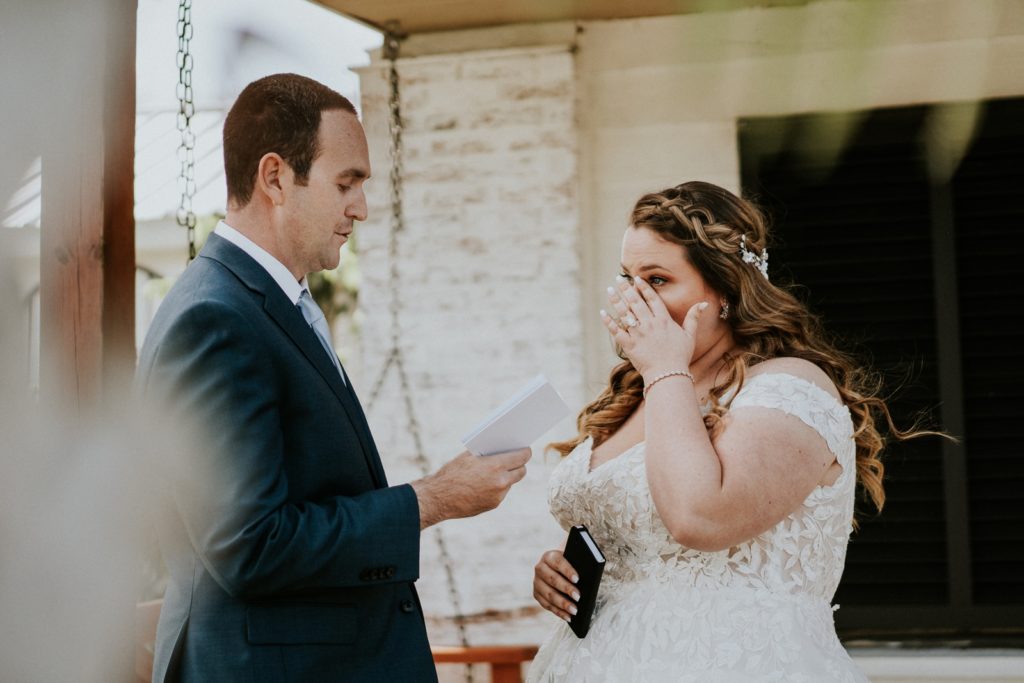 Bride wipes away tear during private vow reading