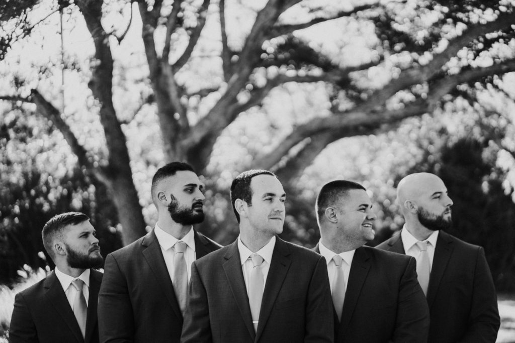 Black and white artistic photo of groomsmen profiles FL wedding photography