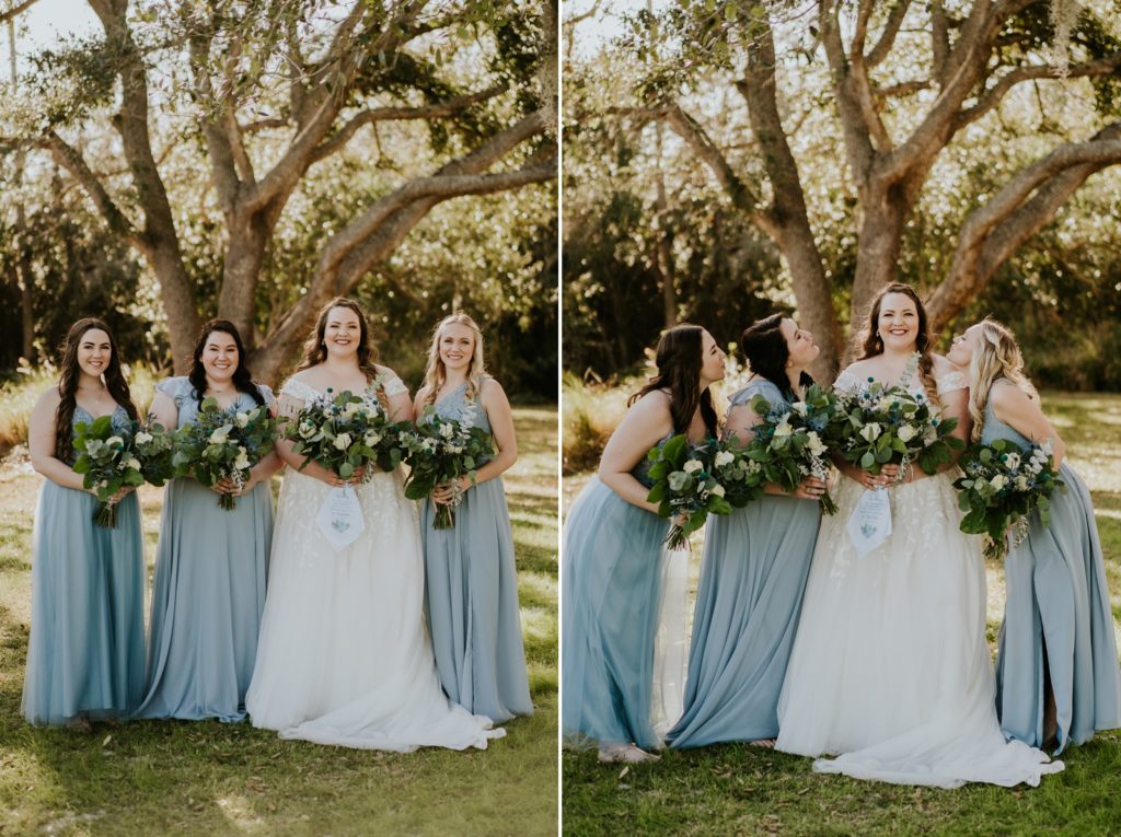 Bridesmaids kiss bride under tree wearing dusty blue Azazie dresses FL wedding photography