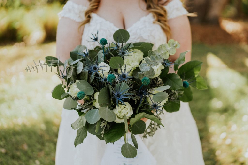 Rustic bridal bouquet with sea holy and eucalyptus greenery by Julie Miner Events 
