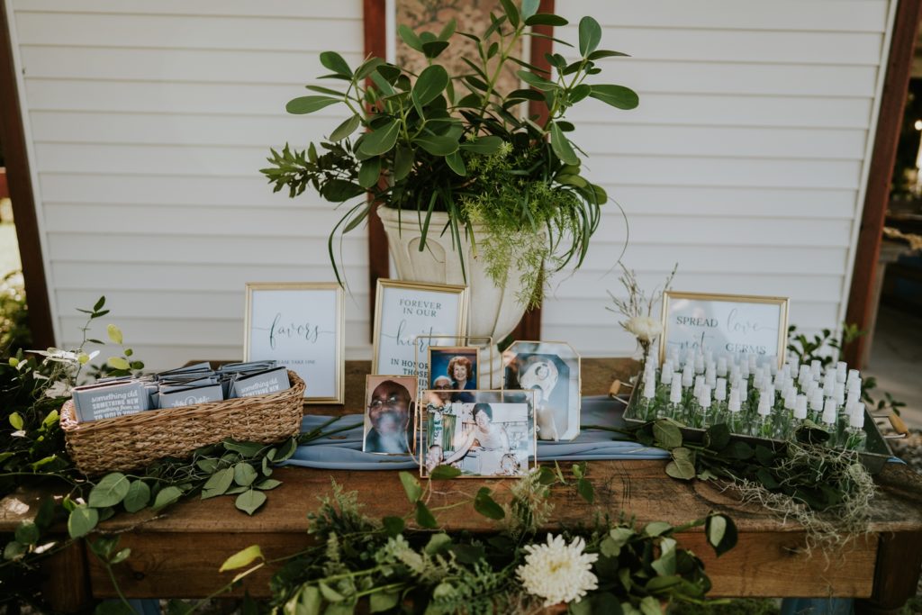 Memorial table with picture frames and greenery Florida wedding photography