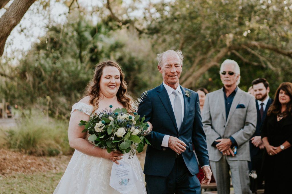 Father walking bride down the aisle for outdoor ceremony